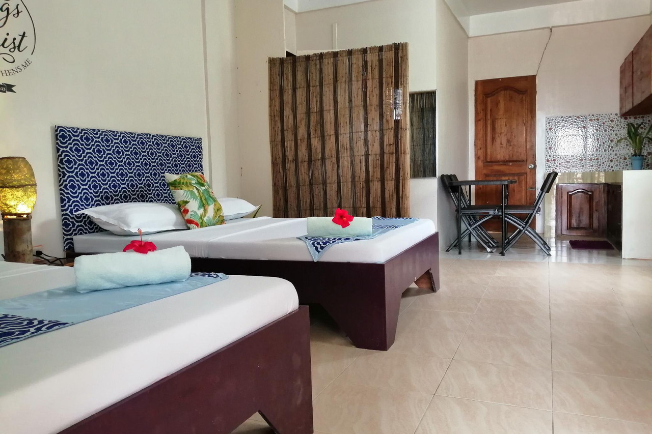 Standard Room at Happy's Homestay — twin beds with blue headboards