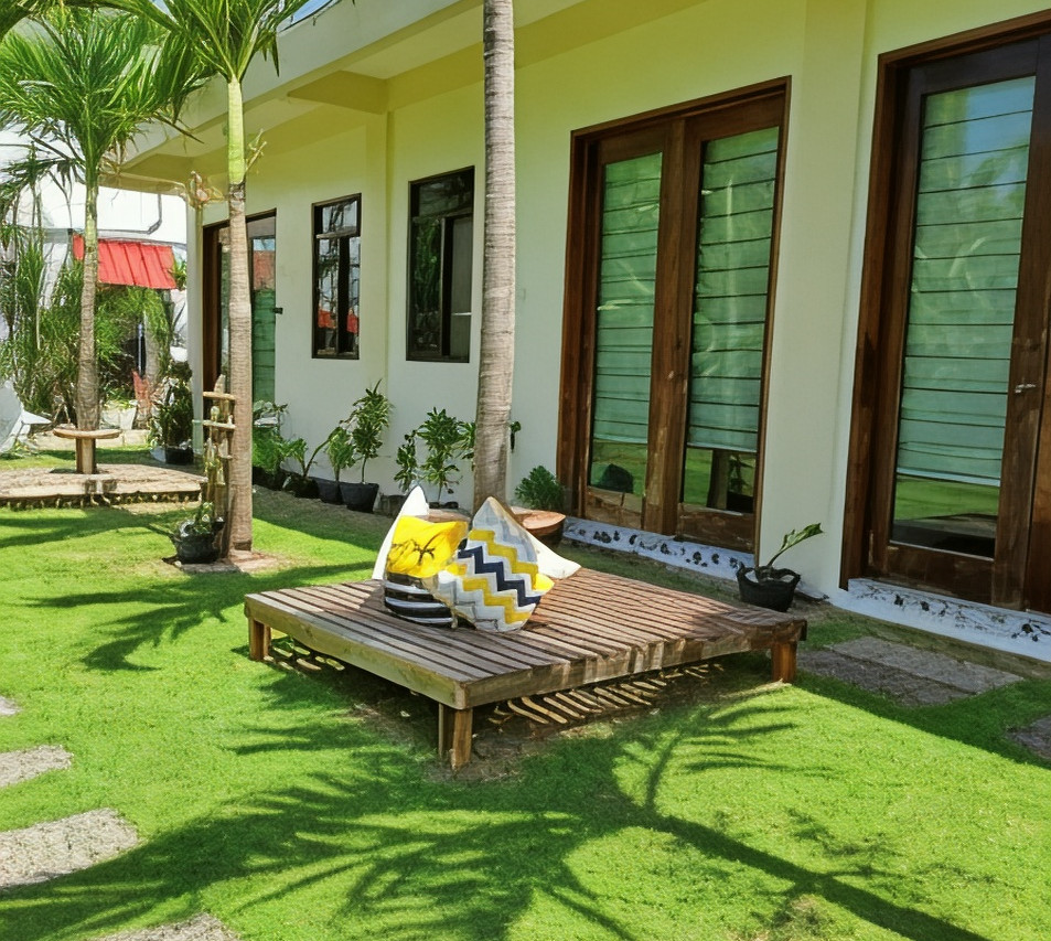 Garden lounge area at Happy's Homestay with wooden daybed